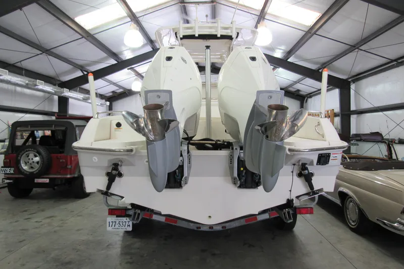 Slide: The Image of 2019 Boston Whaler 270 Dauntless boat with dual outboard engines in a garage. - 6