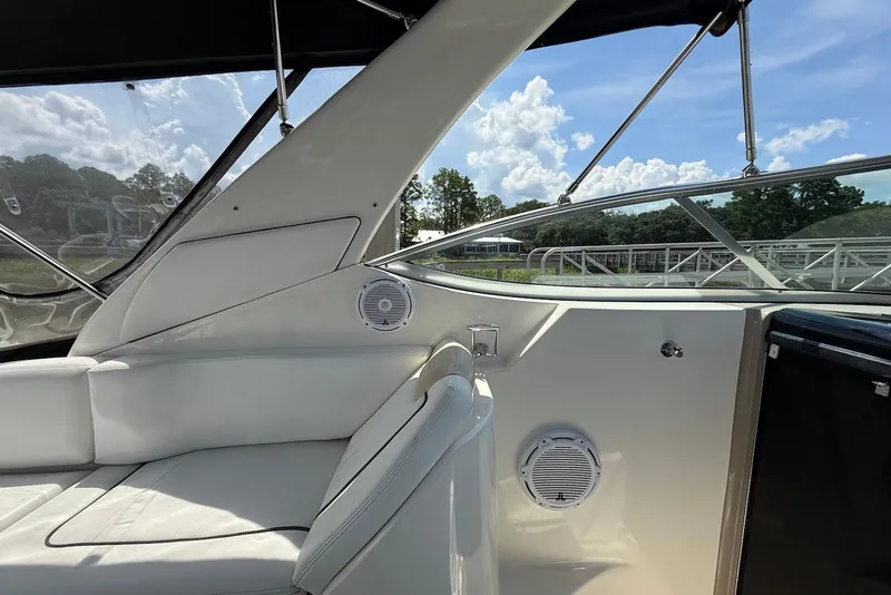 Slide: The Image of Interior view of 2009 Sea Ray 270 Sundancer boat with white seating and speakers. - 15