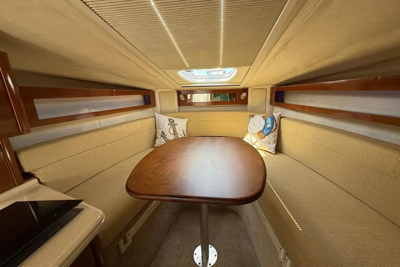 Slide: The Image of 2009 Sea Ray 270 Sundancer cabin interior with dining area and skylight. - 25