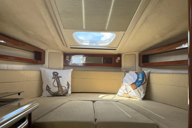 Slide: The Image of Interior cabin of 2009 Sea Ray 270 Sundancer with skylight and nautical-themed pillows. - 29