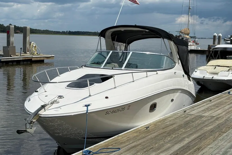 Slide: The Image of 2009 Sea Ray 270 Sundancer docked at a marina under cloudy skies. - 3