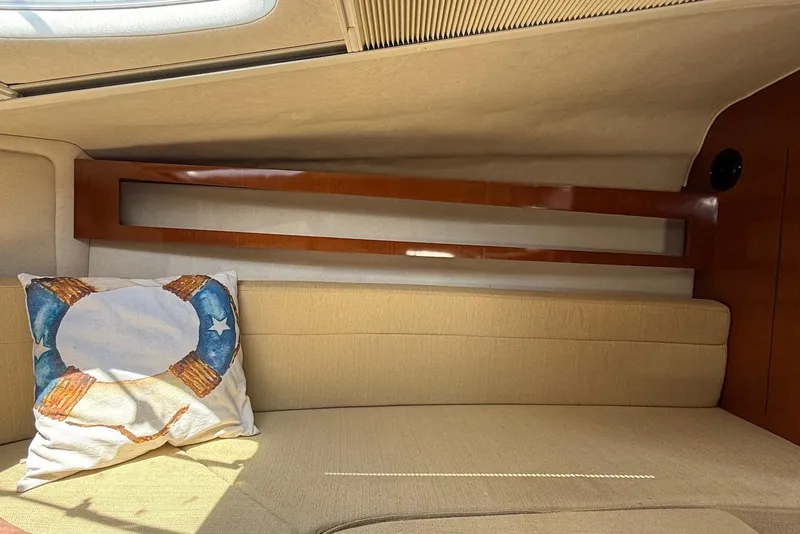 Slide: The Image of Interior of 2009 Sea Ray 270 Sundancer with beige seating and nautical-themed pillow. - 31