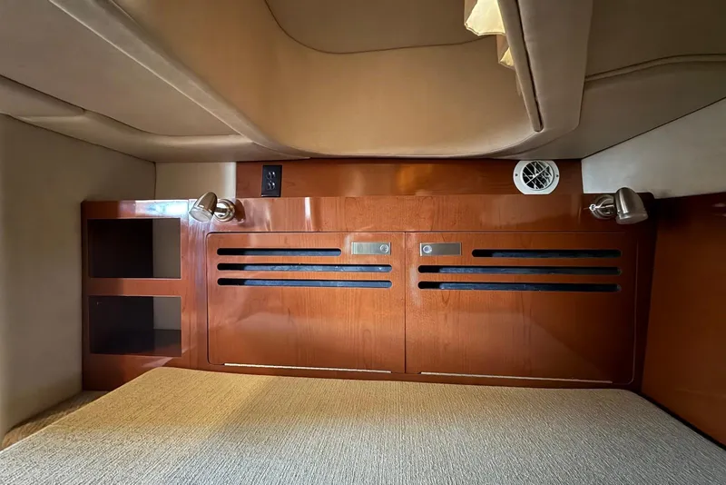 Slide: The Image of 2009 Sea Ray 270 Sundancer cabin interior with wood paneling and lighting fixtures. - 32