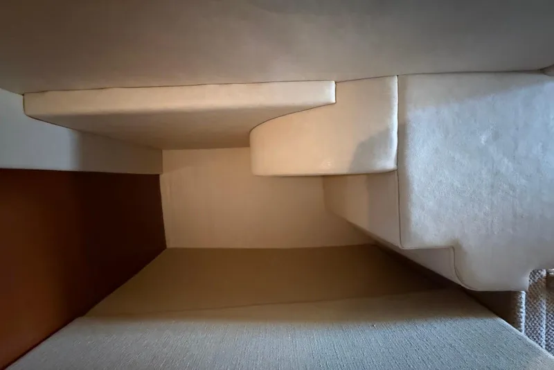 Slide: The Image of Interior cabin view of 2009 Sea Ray 270 Sundancer, featuring beige upholstery and compact design. - 33