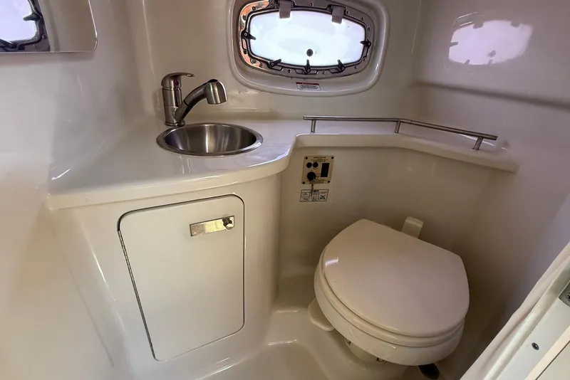 Slide: The Image of Compact bathroom in 2009 Sea Ray 270 Sundancer boat with sink and toilet. - 34