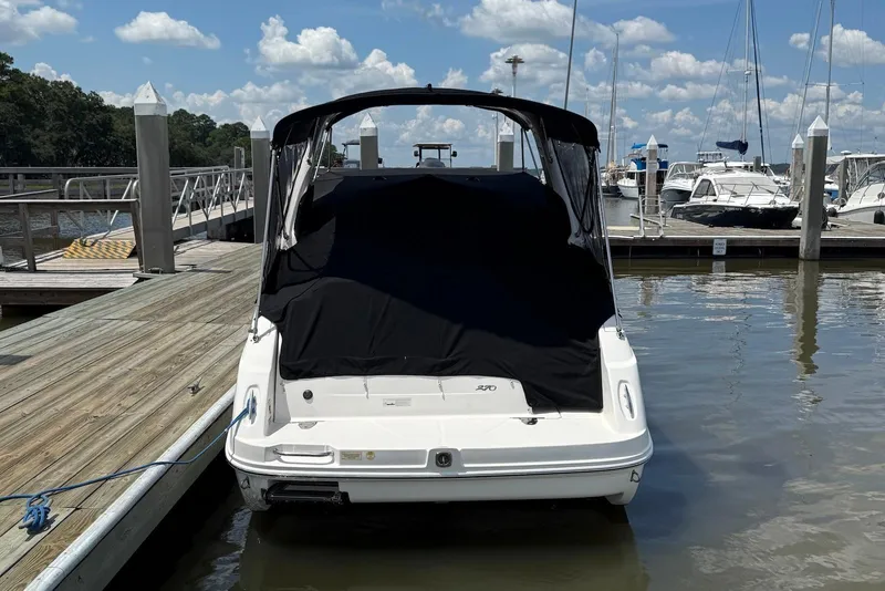Slide: The Image of 2009 Sea Ray 270 Sundancer docked at marina under clear blue sky. - 5