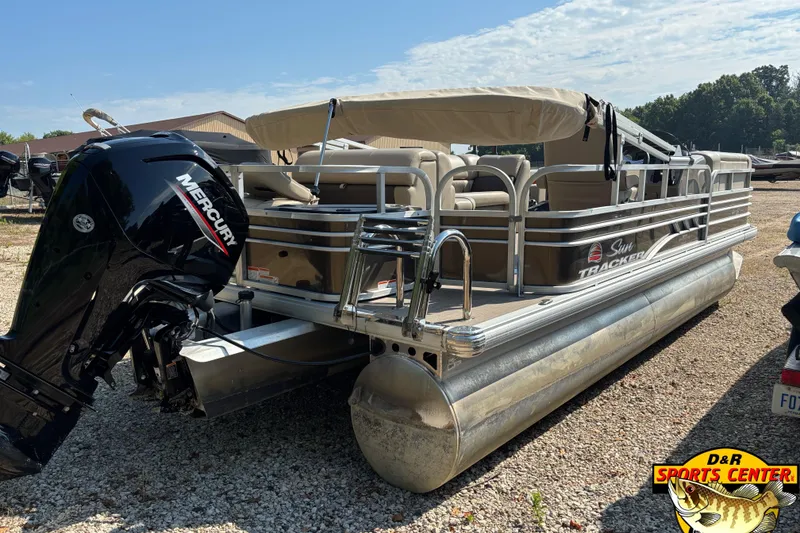 Slide: The Image of 2023 Sun Tracker SportFish 20 DLX pontoon boat with Mercury engine, parked outdoors. - 4