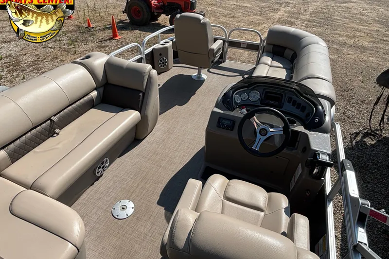Slide: The Image of 2023 Sun Tracker SportFish 20 DLX pontoon boat interior with beige seating and steering console. - 8