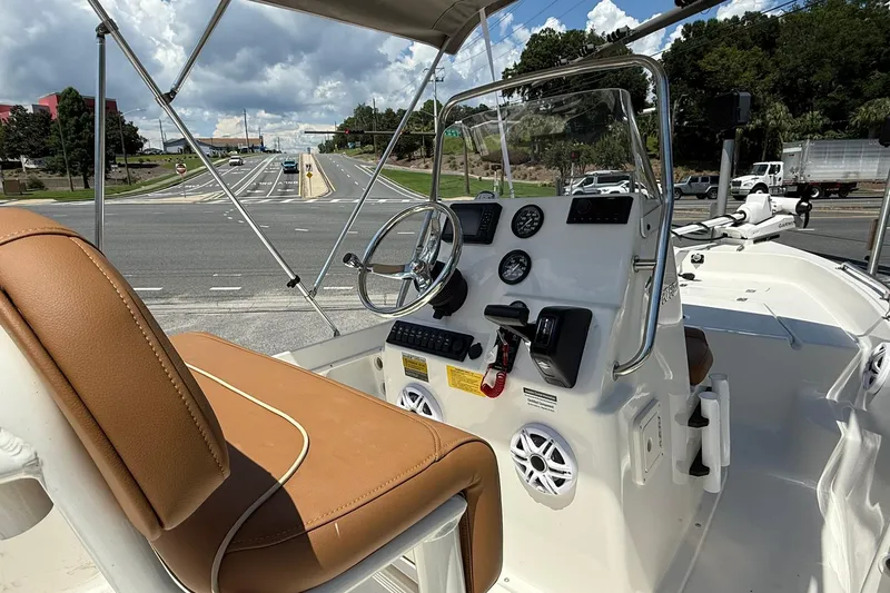 Slide: The Image of 2026 Key West 1720 Center Console boat interior with steering wheel and dashboard controls. - 5