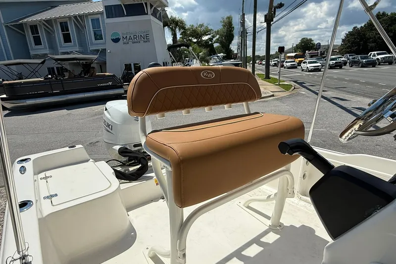 Slide: The Image of 2026 Key West 1720 Center Console boat with tan seating, parked near Emerald Coast Marine. - 6