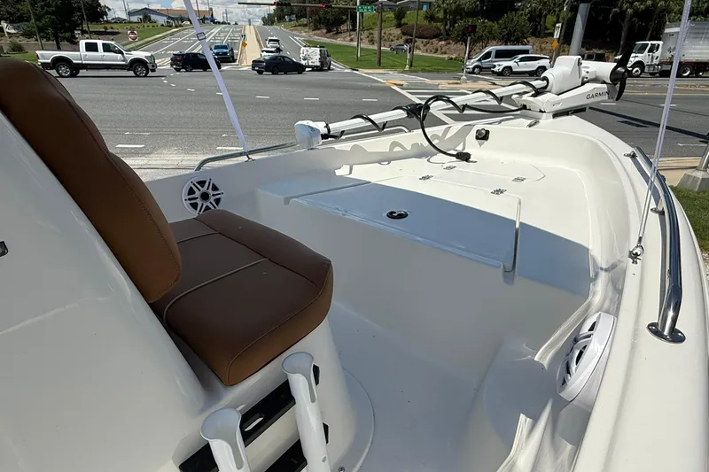 Slide: The Image of 2026 Key West 1720 Center Console boat interior with brown seating, parked near a busy intersection. - 7