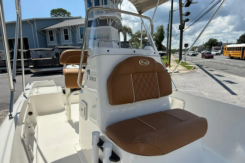 Slide: The Image of 2026 Key West 1720 Center Console boat with brown seating, parked near a street. - 8