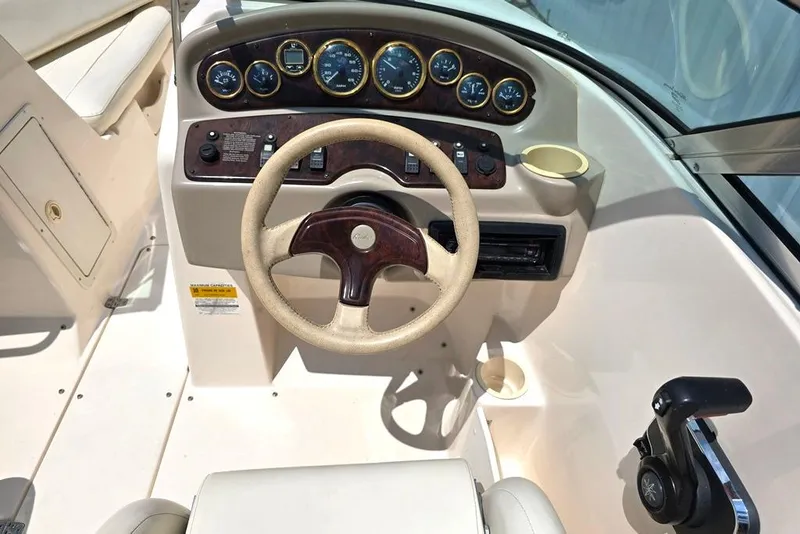 Slide: The Image of 2002 Rinker 212 Captiva BR boat dashboard with steering wheel and instrument panel. - 12