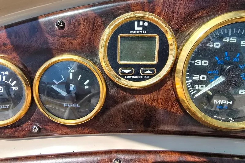 Slide: The Image of Dashboard of 2002 Rinker 212 Captiva BR with gauges and Lowrance depth finder. - 13