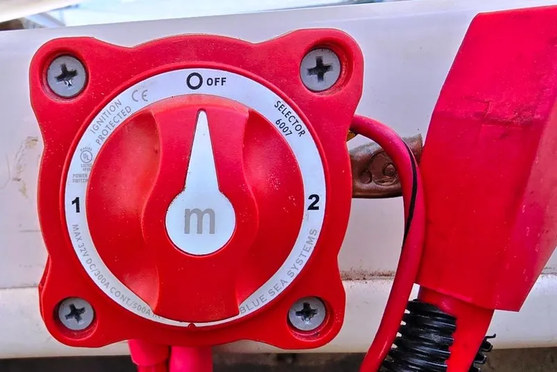 Slide: The Image of Red battery selector switch on a 2002 Rinker 212 Captiva BR boat. - 17