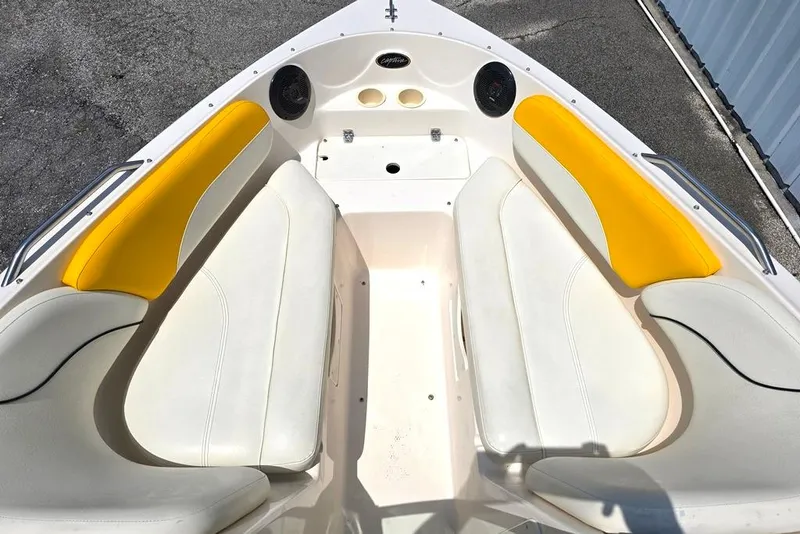 Slide: The Image of 2002 Rinker 212 Captiva BR boat interior with yellow and white seating. - 6