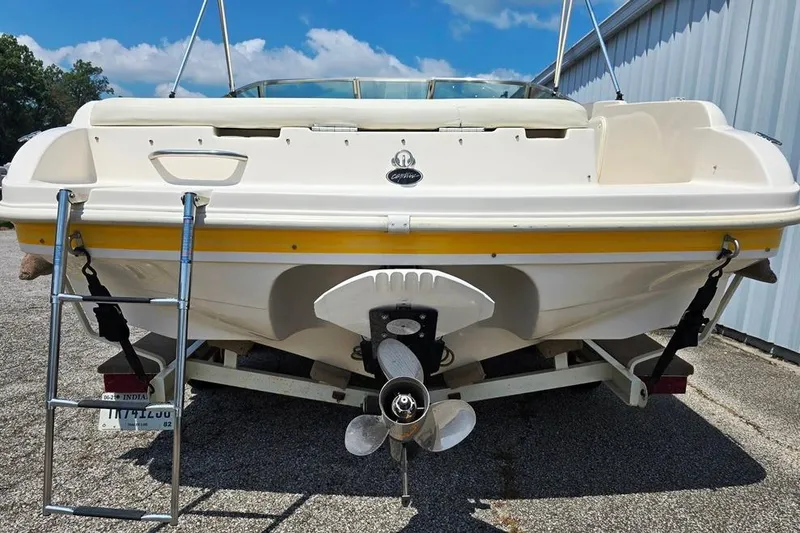 Slide: The Image of 2002 Rinker 212 Captiva BR boat on trailer, rear view with ladder and propeller. - 8