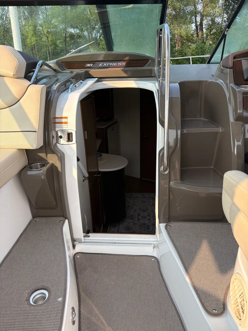 Slide: The Image of 2017 Cruisers Yachts 380 Express interior entrance with seating and steps. - 12