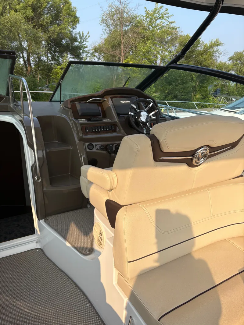 Slide: The Image of 2017 Cruisers Yachts 380 Express helm with beige seating and modern controls. - 13