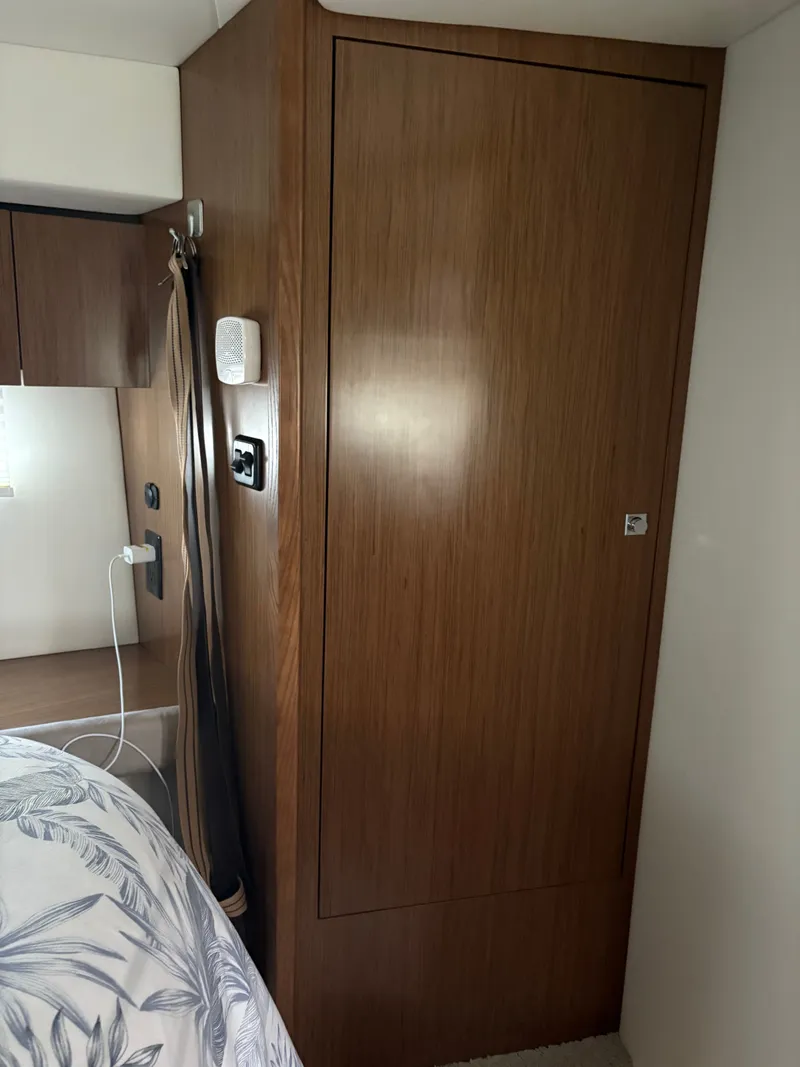 Slide: The Image of Interior of 2017 Cruisers Yachts 380 Express, featuring wooden cabinetry and modern design elements. - 16