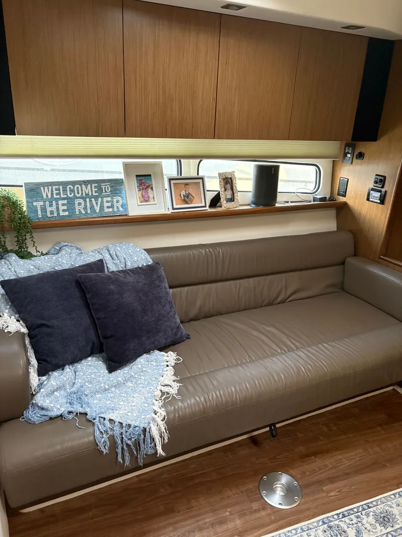 Slide: The Image of Interior of 2017 Cruisers Yachts 380 Express with cozy sofa and decor. - 17