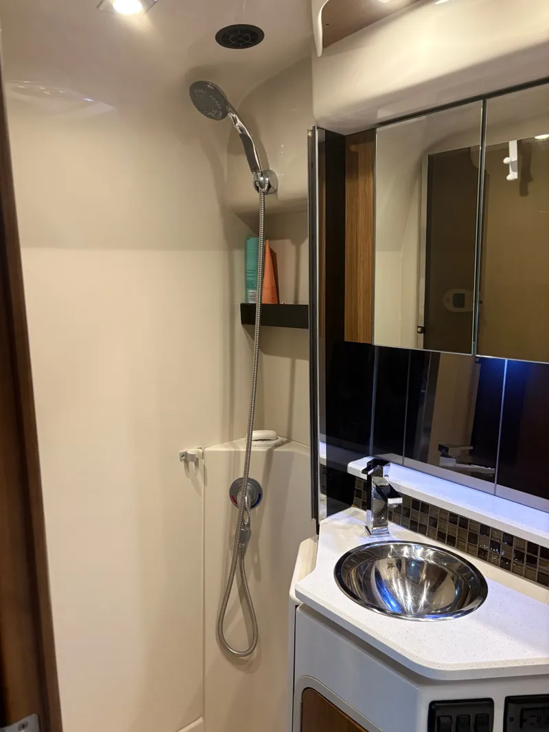 Slide: The Image of 2017 Cruisers Yachts 380 Express bathroom with shower, sink, and mirror. - 18