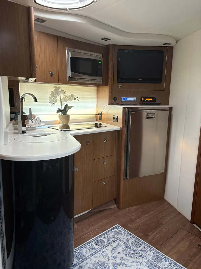 Slide: The Image of Luxurious 2017 Cruisers Yachts 380 Express interior with modern kitchen amenities. - 24