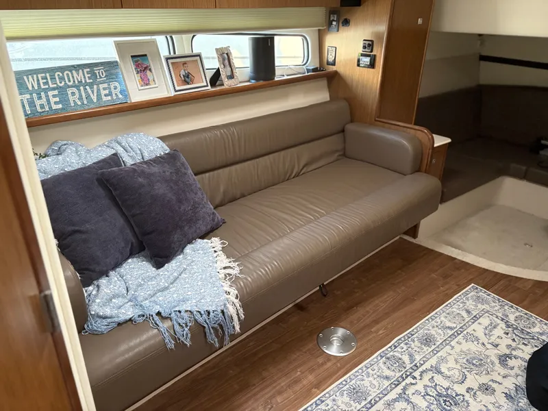 Slide: The Image of Interior of 2017 Cruisers Yachts 380 Express with cozy sofa and decorative pillows. - 25