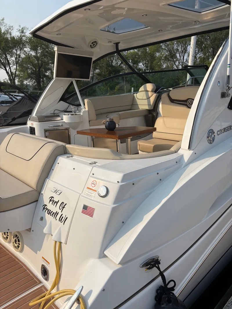 Slide: The Image of 2017 Cruisers Yachts 380 Express with luxurious seating and outdoor table, docked at Port of Prescott. - 4