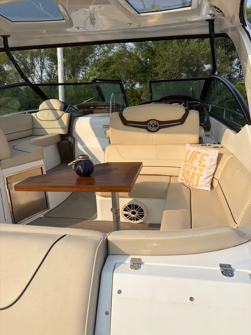 Slide: The Image of Luxurious interior of 2017 Cruisers Yachts 380 Express with beige seating and wooden table. - 7