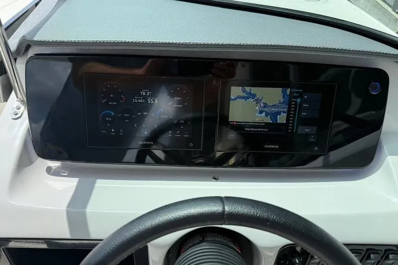 Slide: The Image of 2023 Regal LS2 dashboard with dual Garmin displays showing navigation and engine data. - 17