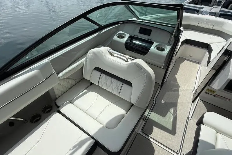 Slide: The Image of 2023 Regal LS2 boat interior with luxurious white seating and modern dashboard design. - 2