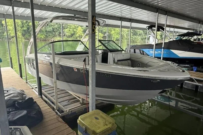 Slide: The Image of 2023 Regal LS2 boat docked in a covered marina slip. - 3