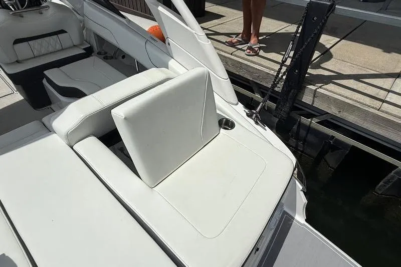 Slide: The Image of 2023 Regal LS2 boat interior with white seating at a dock. - 5