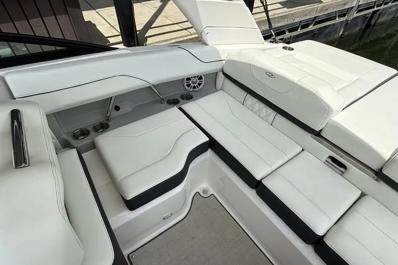 Slide: The Image of 2023 Regal LS2 boat interior with white cushioned seating and cup holders. - 6