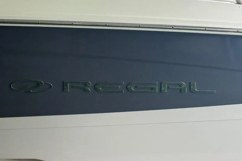 Slide: The Image of 2023 Regal LS2 boat logo on dark blue background. - 9