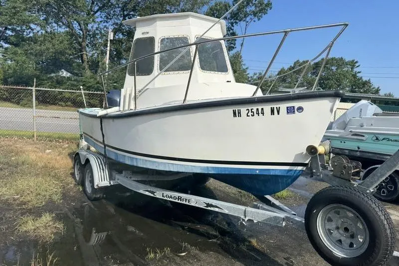 The Image of 2001 ROS Boats 19 RUNABOUT on trailer, parked outdoors, with visible registration number. - 0