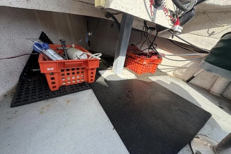 Slide: The Image of Interior of 2001 ROS Boats 19 RUNABOUT with storage crates and equipment. - 11