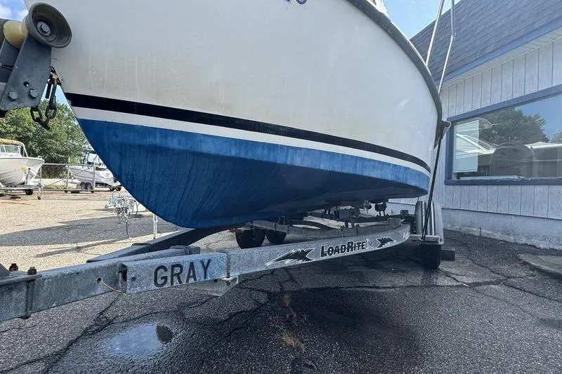 Slide: The Image of 2001 ROS Boats 19 RUNABOUT on LoadRite trailer, parked outside a building. - 2