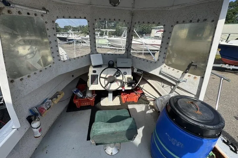 Slide: The Image of Interior of a 2001 ROS Boats 19 RUNABOUT, featuring steering wheel and navigation equipment. - 5