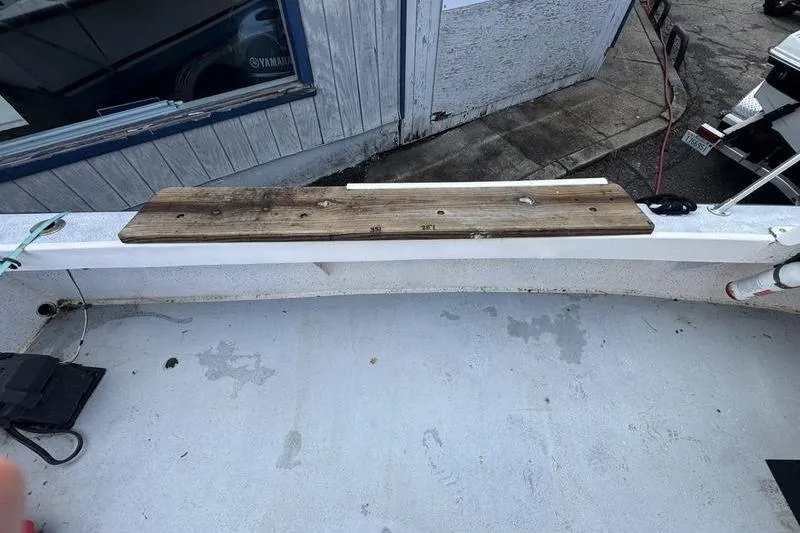 Slide: The Image of 2001 ROS Boats 19 RUNABOUT deck with wooden plank and weathered surface. - 6