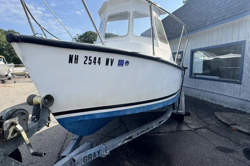 Slide: The Image of 2001 ROS Boats 19 RUNABOUT on trailer, parked outside a building. - 7