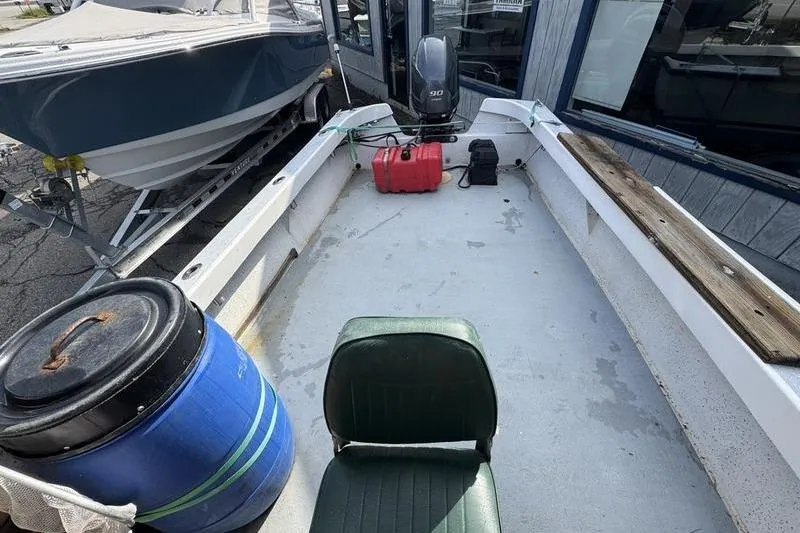 Slide: The Image of 2001 ROS Boats 19 RUNABOUT interior with motor, fuel tank, and seating. - 8