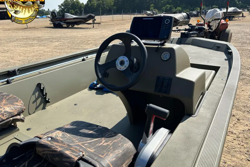 Slide: The Image of 2019 Tracker Grizzly 1754 SC boat interior with steering wheel and control panel. - 3