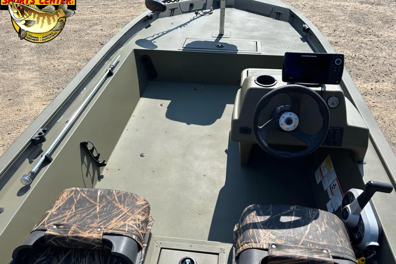 Slide: The Image of 2019 Tracker Grizzly 1754 SC boat interior with steering console and camouflage seats. - 5
