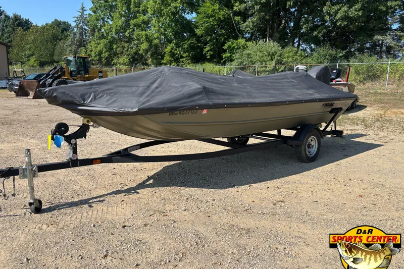 Slide: The Image of 2019 Tracker Grizzly 1754 SC boat with cover on trailer, parked outdoors. - 7