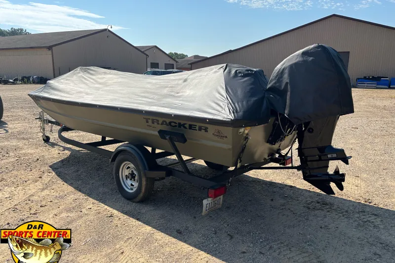 Slide: The Image of 2019 Tracker Grizzly 1754 SC boat on trailer, covered, parked outdoors. - 8