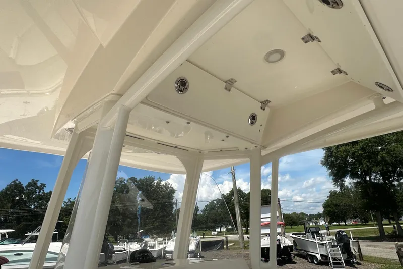 Slide: The Image of 2023 Cobia 262 Center Console boat interior with overhead storage and lighting. - 18