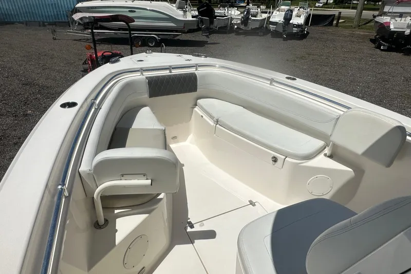 Slide: The Image of 2023 Cobia 262 Center Console boat interior with white seating and spacious layout. - 19