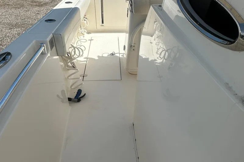 Slide: The Image of 2023 Cobia 262 Center Console boat interior with rod holders and storage compartments. - 22